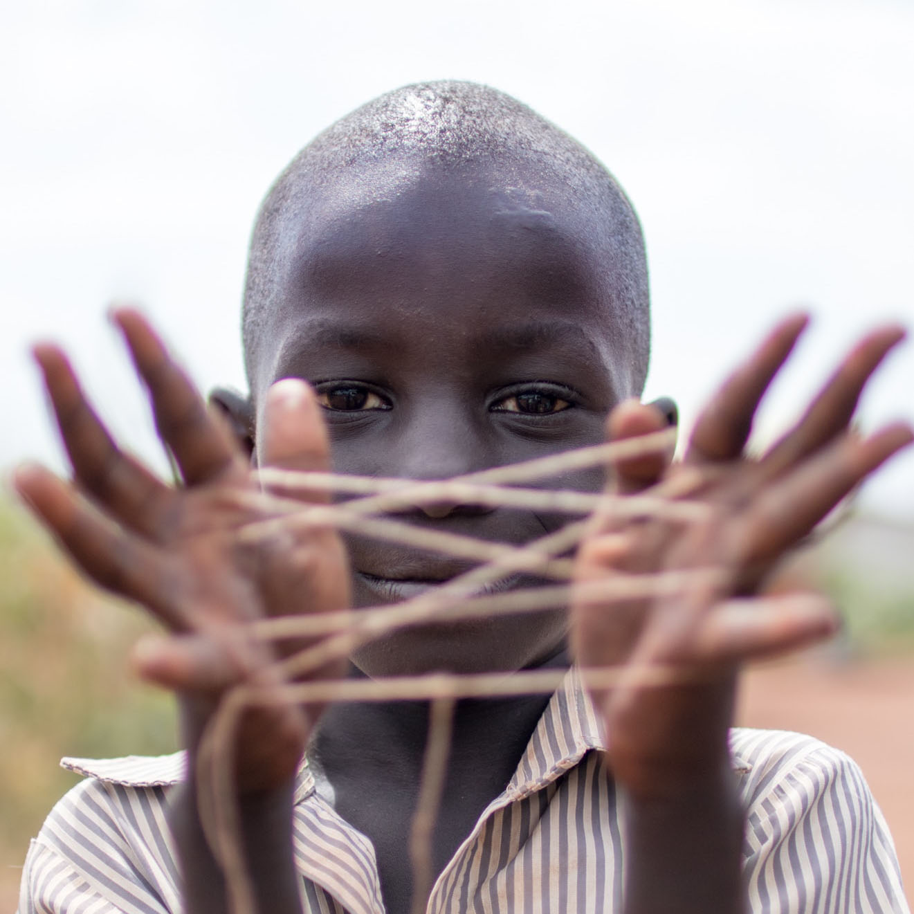 Child playing string game
